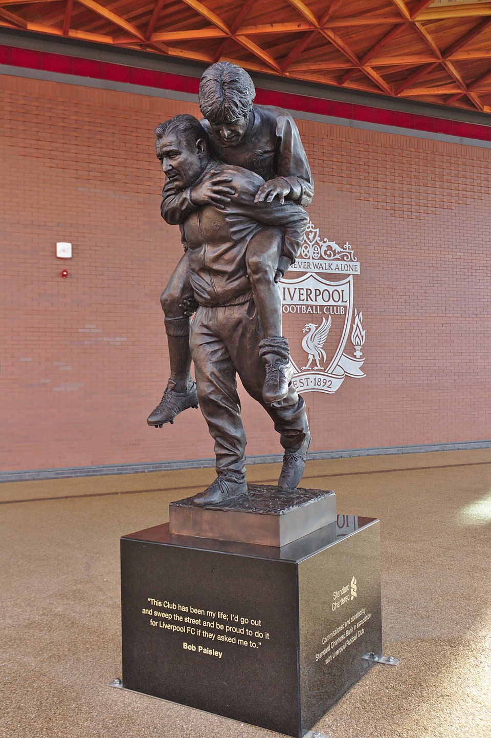 Bob Paisley statue at Paisley Square, Anfield, carrying Emlyn Hughes